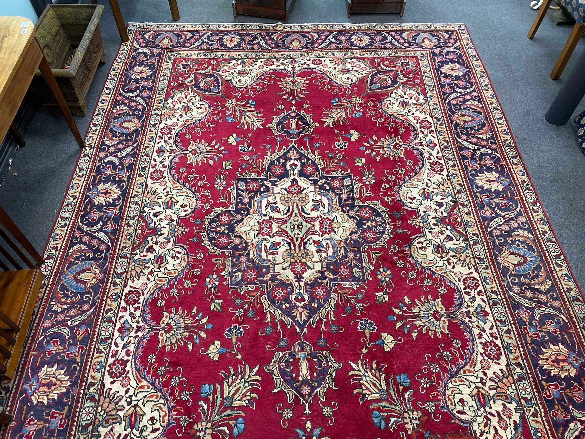 A North West Persian red ground carpet 290cm x 246cm.